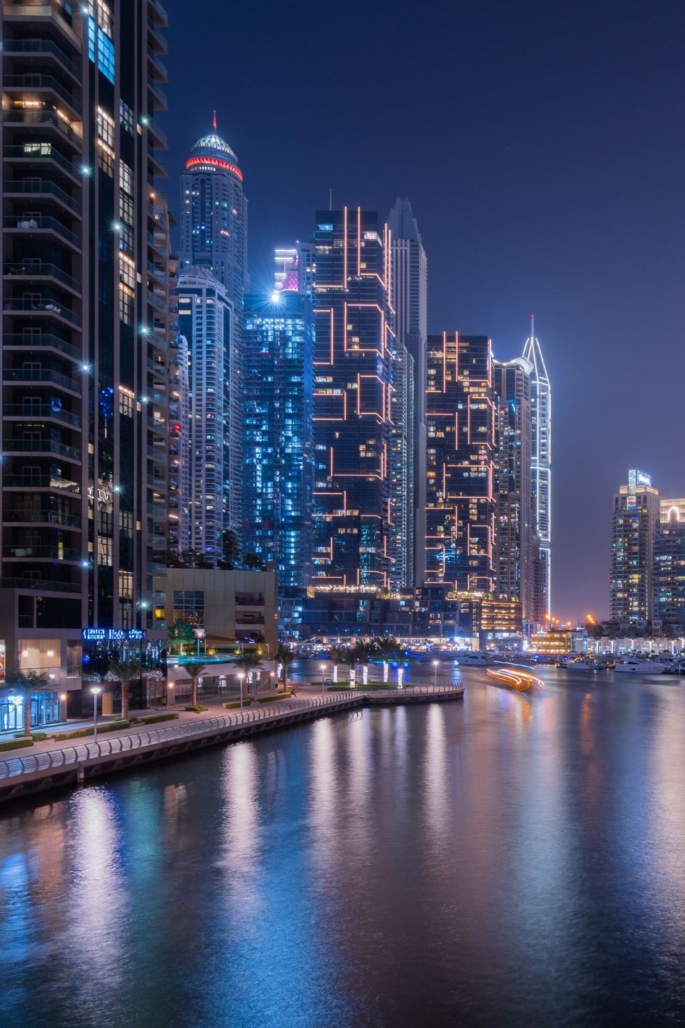 Dubai Marina skyline at night with illuminated high-rise buildings and waterfront views